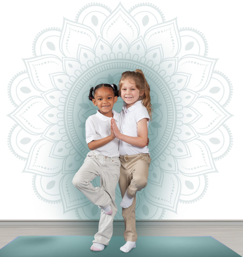 two middle school girls in a yoga pose in front of a mandala